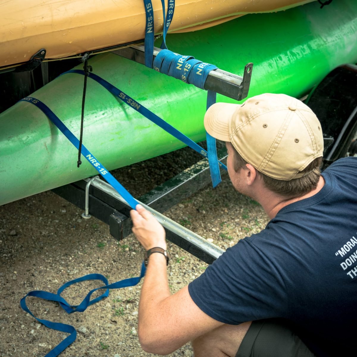 Instructors preparing for an expedition by securing a set of kayaks.