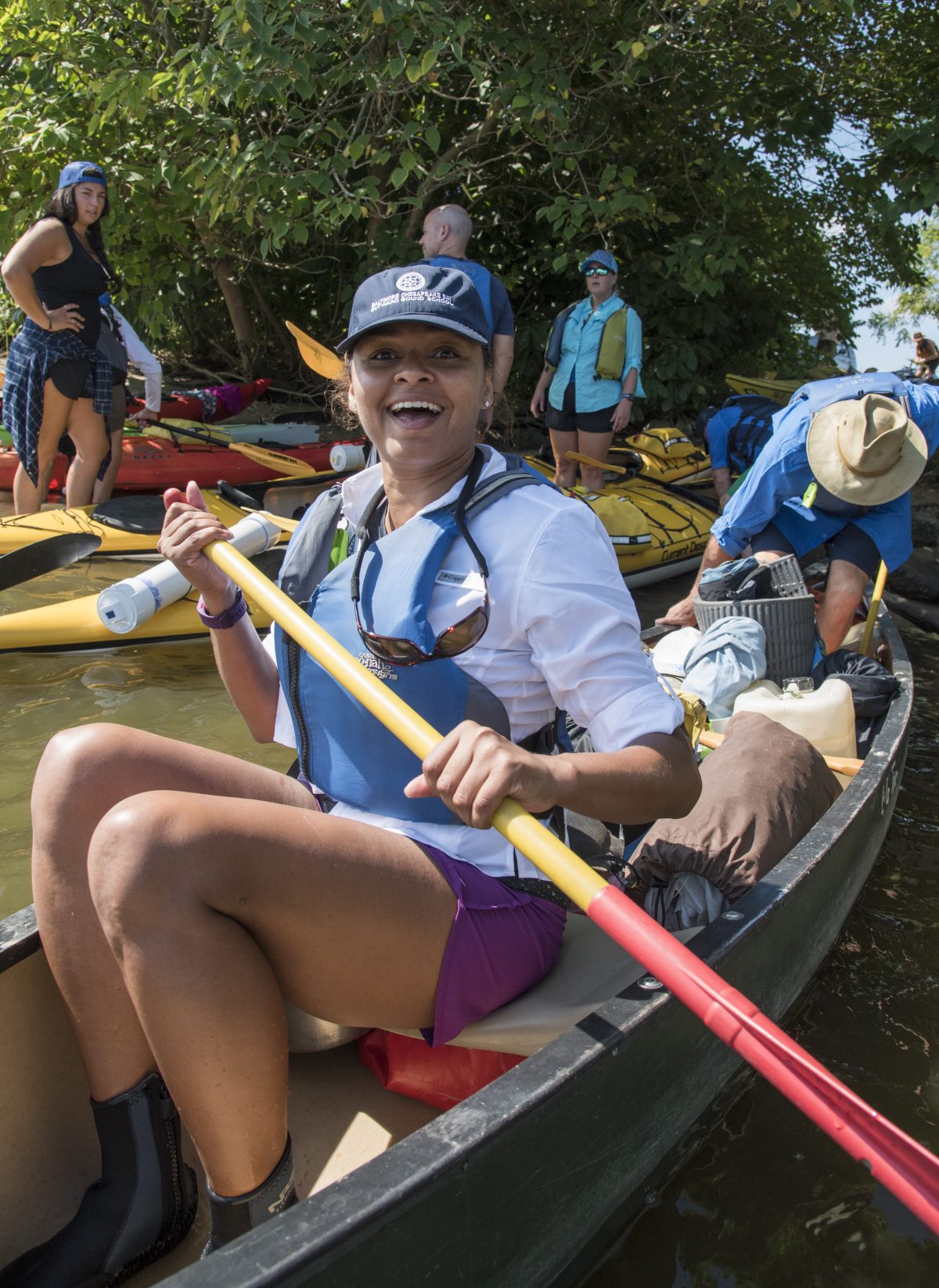 Ganesha paddling the Bay on expedition Vice-Chair Martin smiles while sitting in a canoe on an Outward Bound expedition.