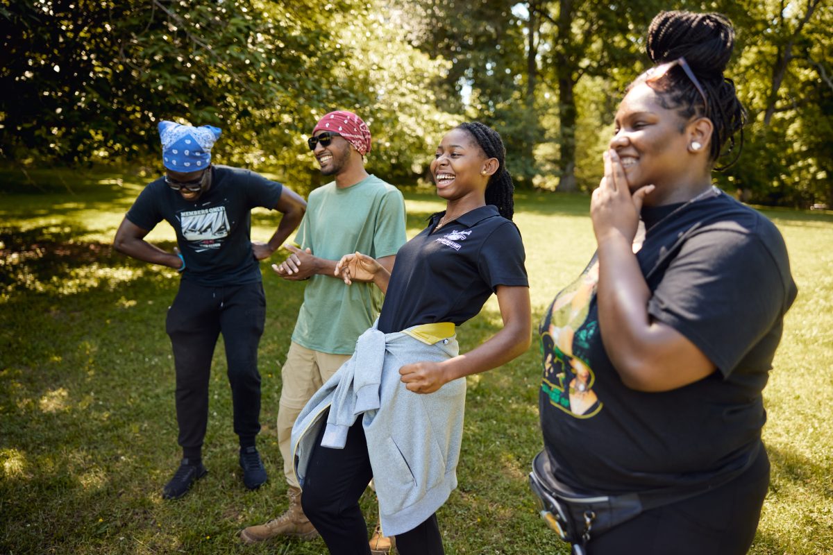 4 ROTC cadets laughing while playing a teambuilding game