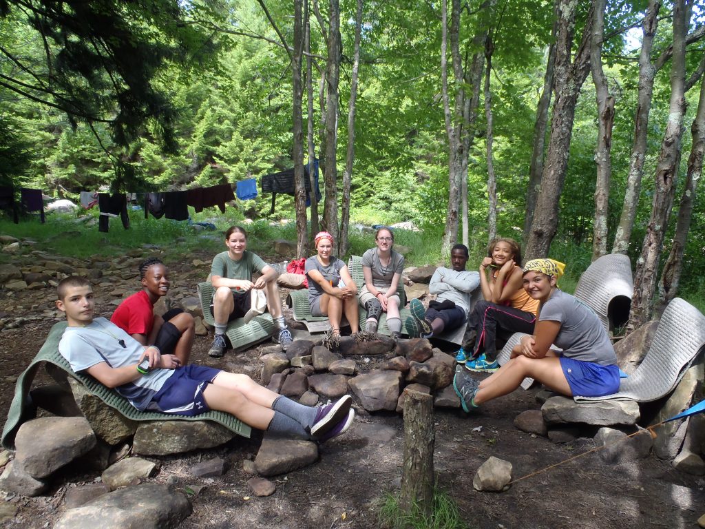 A YLC student group sitting around a fire pit