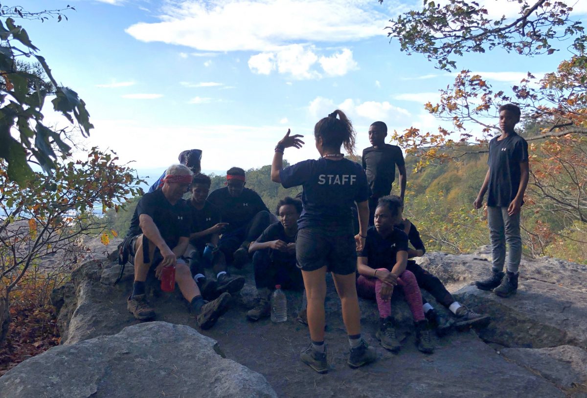 Maria Talking to Students With a View in the Background