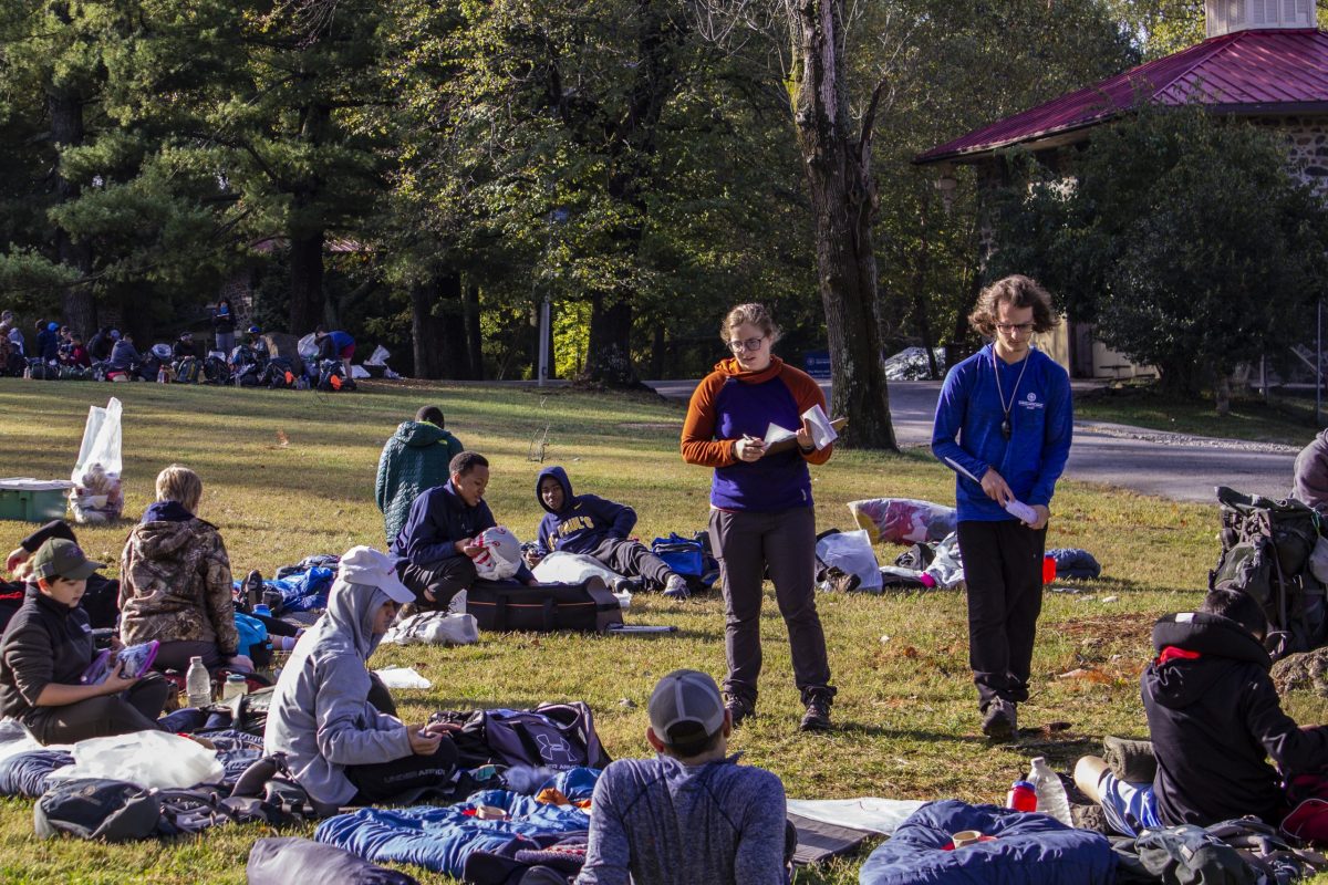 Two instructors prepare a group of students for their first Outward Bound course.